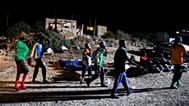 Migrants sleep outside on Lampedusa Island, Italy, Thursday, Sept. 14, 2023.