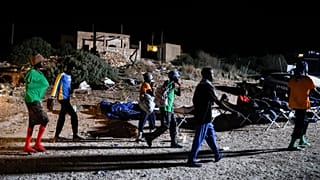Migrants sleep outside on Lampedusa Island, Italy, Thursday, Sept. 14, 2023.