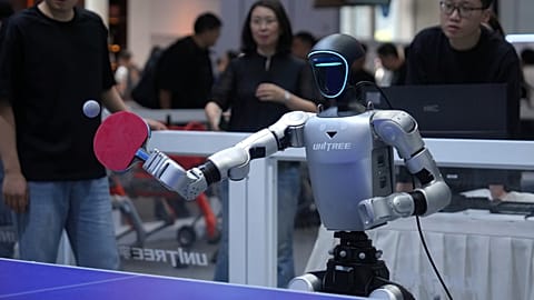 A robot plays table tennis at a Unitree booth during the World Robot Conference in Beijing, Wednesday, Aug. 19, 2026.