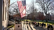  People take photos near a John Harvard statue, left, on the Harvard University campus, 2 Jan., 2024, in Cambridge, Mass. (AP Photo/Steven Senne, File)