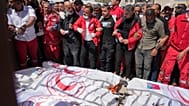 Mourners gather around the bodies of eight Red Crescent responders in Deir al-Balah, Gaza, on 31 March 2025.