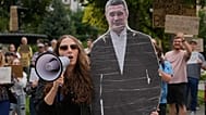 People shout slogans next to a cardboard cutout photo of Mykhailo Fedorov during a rally to protest his dismissal as Ukraine's Defense Minister in Kyiv, Friday, Aug. 14, 2026.