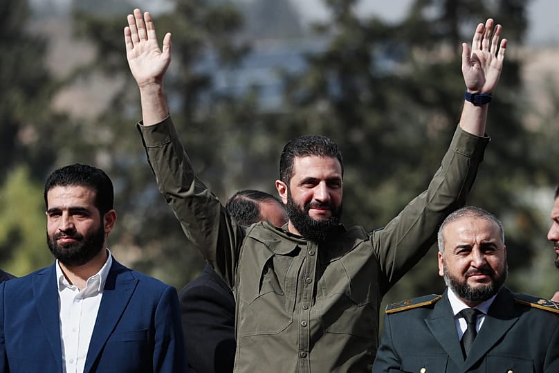 Interim President Ahmad al-Sharaa greets people as he attends celebrations marking the first anniversary of the ousting of Assad in Damascus, Syria, Monday, Dec. 8, 2025