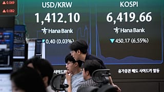 FILE - Currency traders monitor the Korea Composite Stock Price Index (KOSPI) and the foreign exchange rates at the Hana Bank headquarters in Seoul, South Korea, Aug. 19, 2026