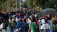 Migrants who crossed from Morocco into Spain are escorted by Spanish police to temporary shelters after being cleared from a beach in Ceuta, 20 August, 2026