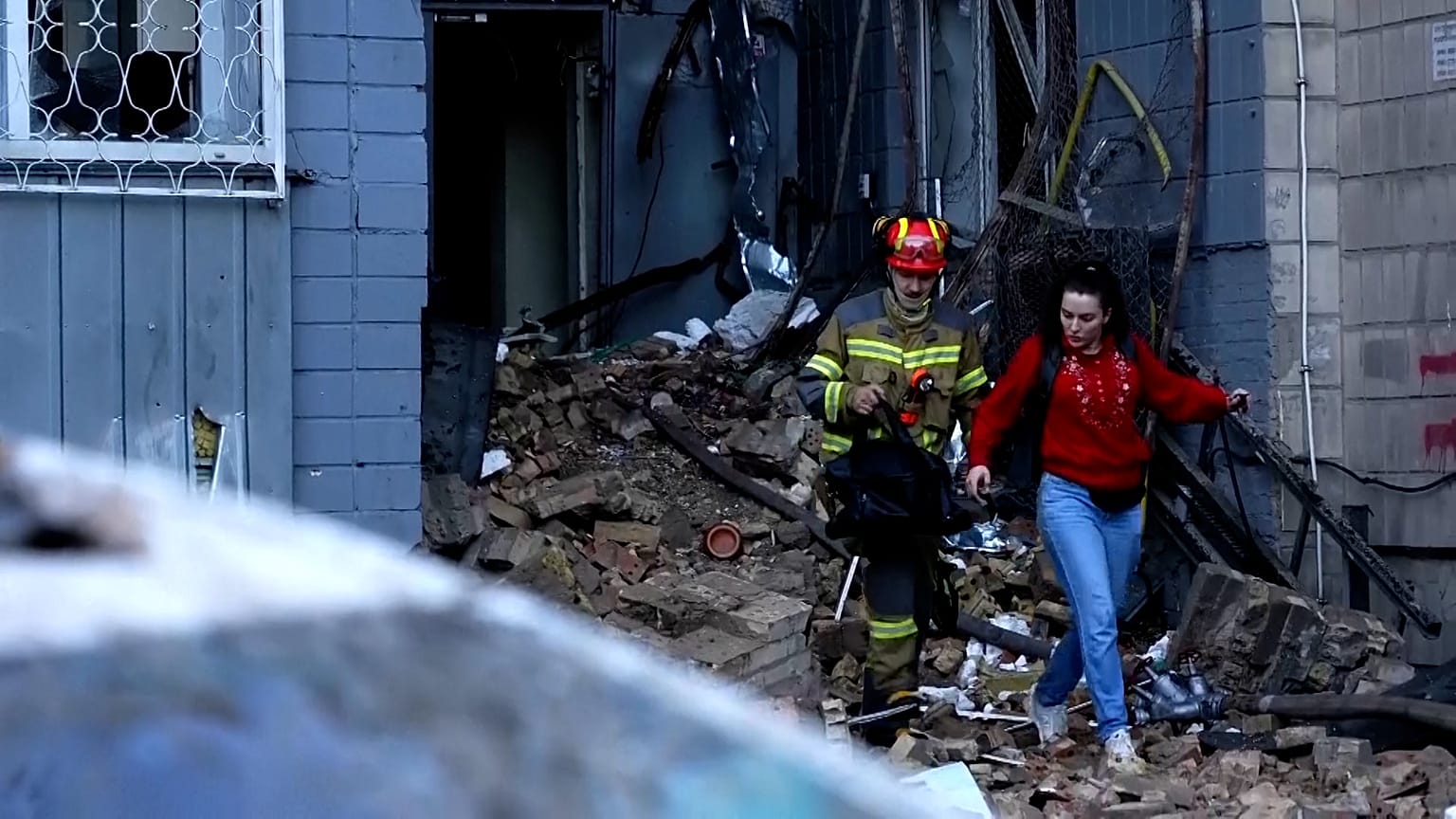 Firefighter helping woman