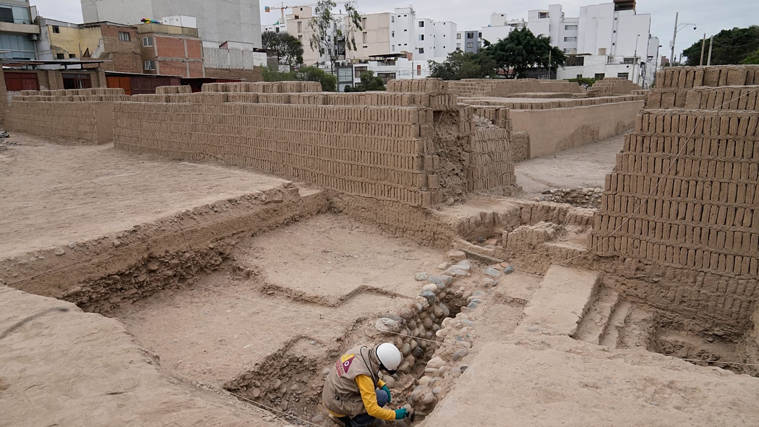 An archaeologist excavates skeletal remains at the Huaca Pucllana archaeological site in Lima, Peru, Tuesday, Aug. 18, 2026.