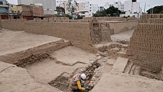 An archaeologist excavates skeletal remains at the Huaca Pucllana archaeological site in Lima, Peru, Tuesday, Aug. 18, 2026.