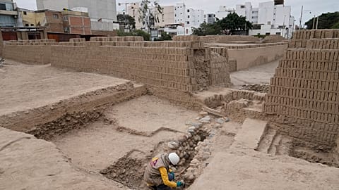 An archaeologist excavates skeletal remains at the Huaca Pucllana archaeological site in Lima, Peru, Tuesday, Aug. 18, 2026.