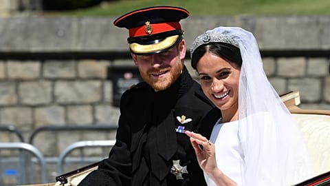 Prince Harry and Meghan wave from their carriage after their wedding at Windsor Castle on 19 May 2018. (Paul Ellis/Pool Photo via AP)