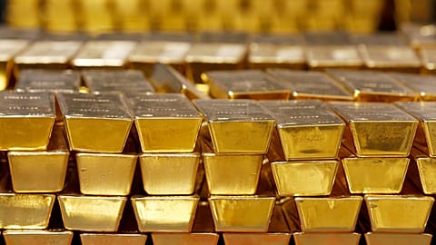 FILE. Gold bars are stacked in a vault at the United States Mint, in West Point, New York, July 2014