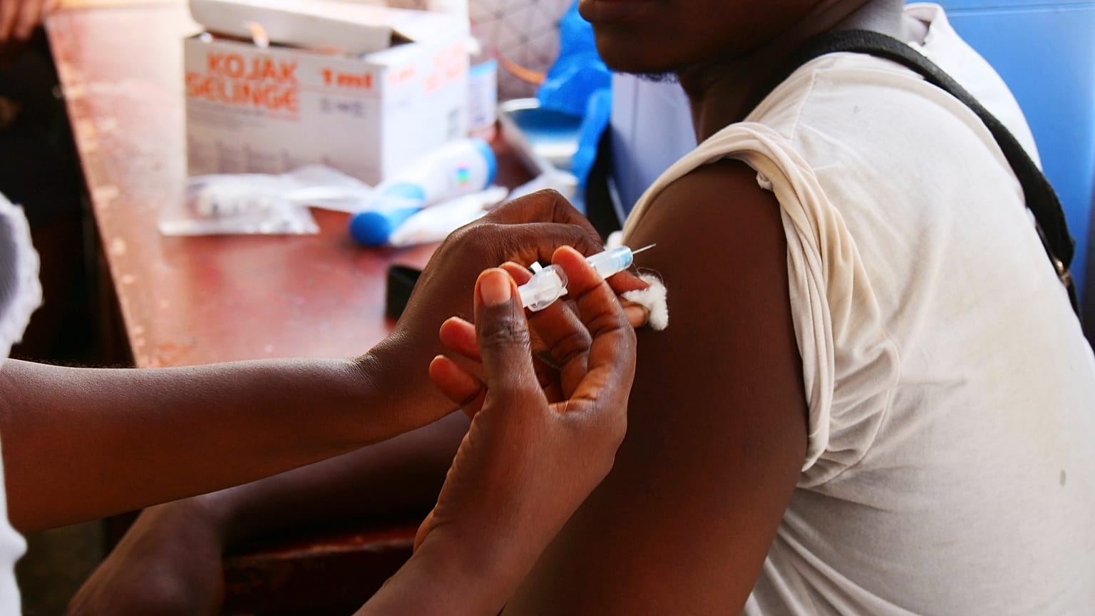 A health worker administers a single-dose of Ebola vaccine to a man at the Christian Maternity Hospital in Freetown, 5 December, 2024