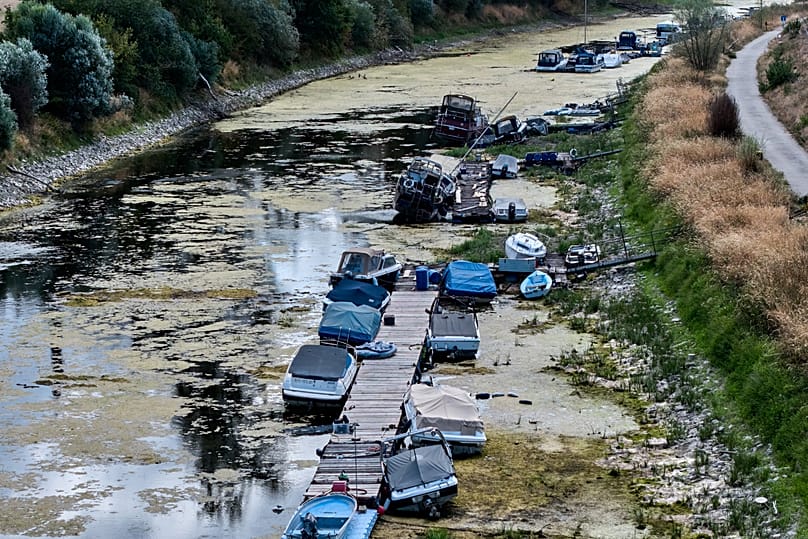 Boats are stranded in a side arm of the river Rhine that is running out of water in Mackenheim, 10 August, 2026