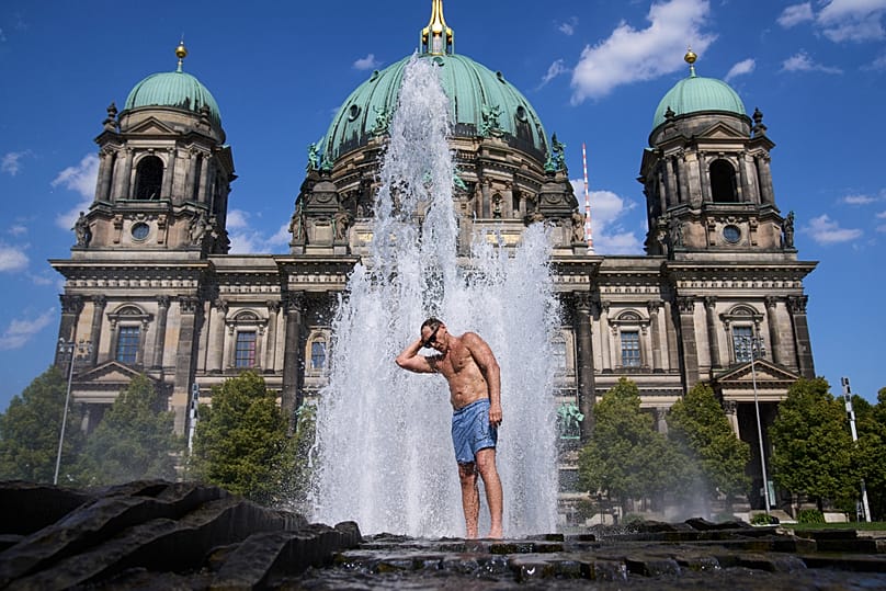 A man cools off in a fountain in front of the Cathedral as temperatures rise in Berlin, 30 July, 2026