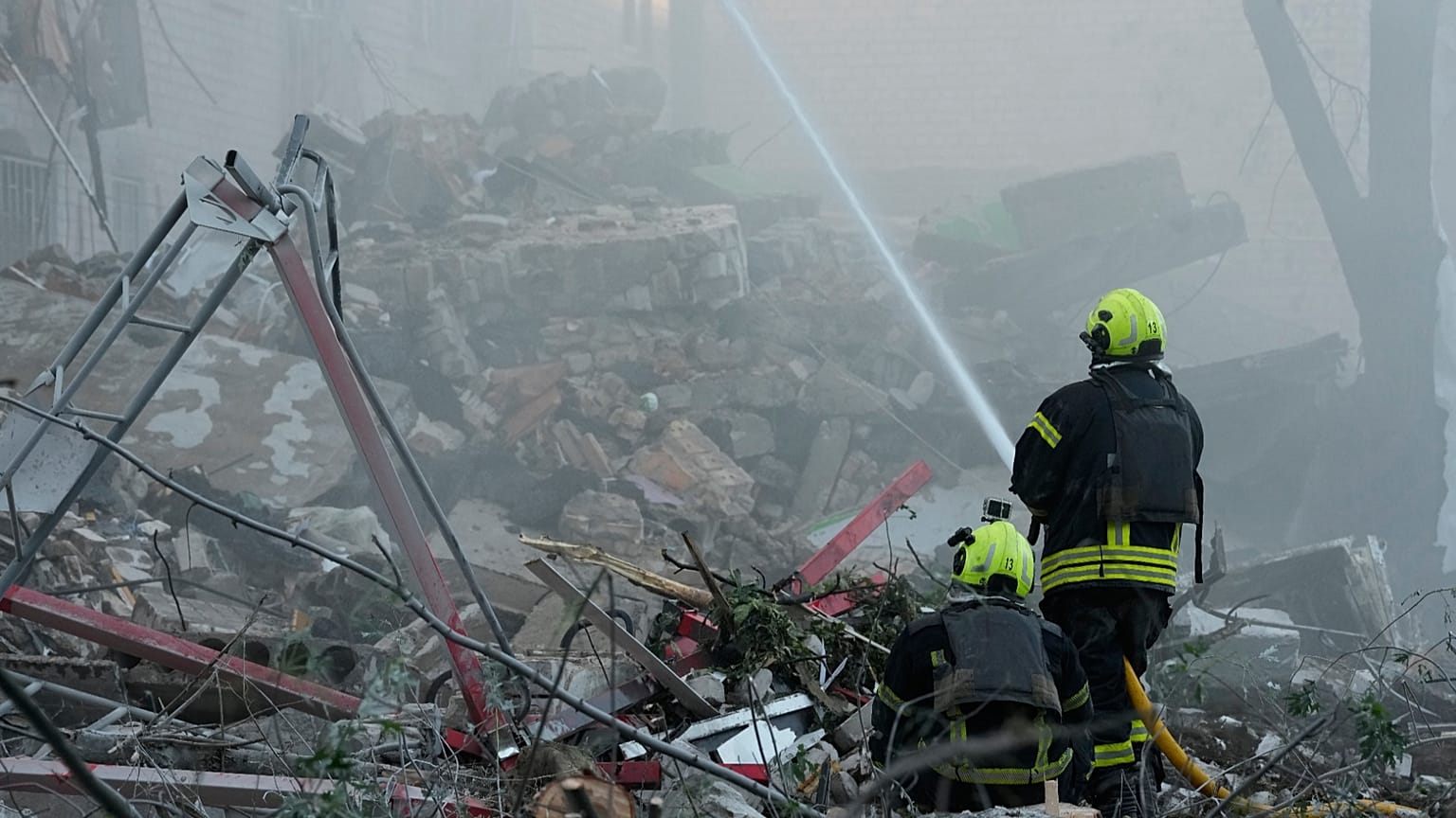 Emergency services personnel work to extinguish a fire after a Russian strike on Kyiv, 2 July, 2026