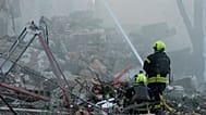 Emergency services personnel work to extinguish a fire after a Russian strike on Kyiv, 2 July, 2026