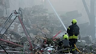 Emergency services personnel work to extinguish a fire after a Russian strike on Kyiv, 2 July, 2026