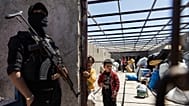 A US-backed Syrian Democratic Forces fighter stands guard at the al-Hol camp in Hasakeh province, 8 May, 2024