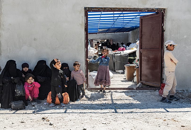Family members of suspected IS fighters wait to be transferred from the al-Hol camp in Hasakeh province, 8 May, 2024