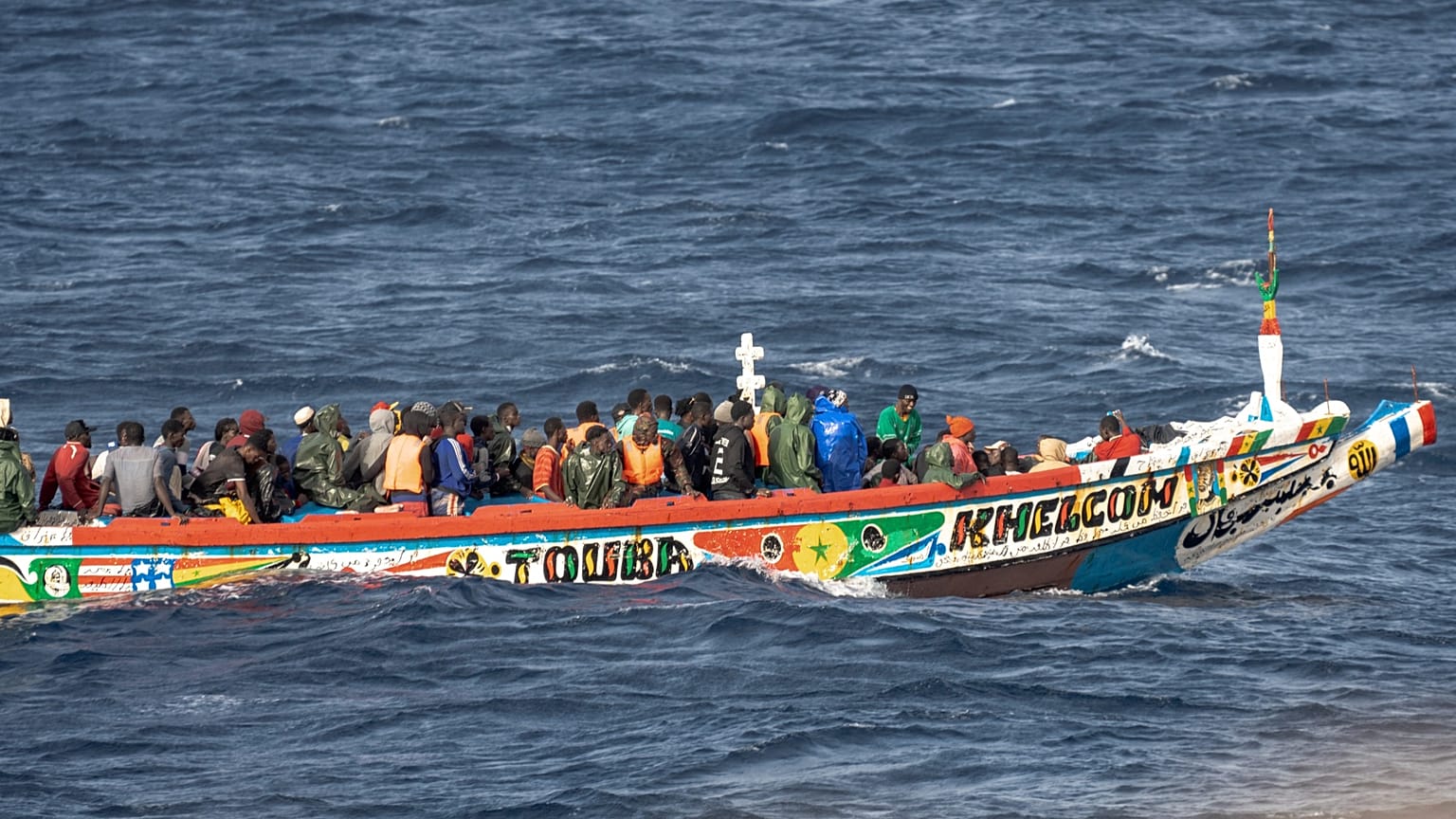 Migrants crowd a wooden boat as they sail to the port in La Restinga on the Canary island of El Hierro, 19 August, 2024