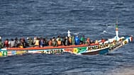 Migrants crowd a wooden boat as they sail to the port in La Restinga on the Canary island of El Hierro, 19 August, 2024
