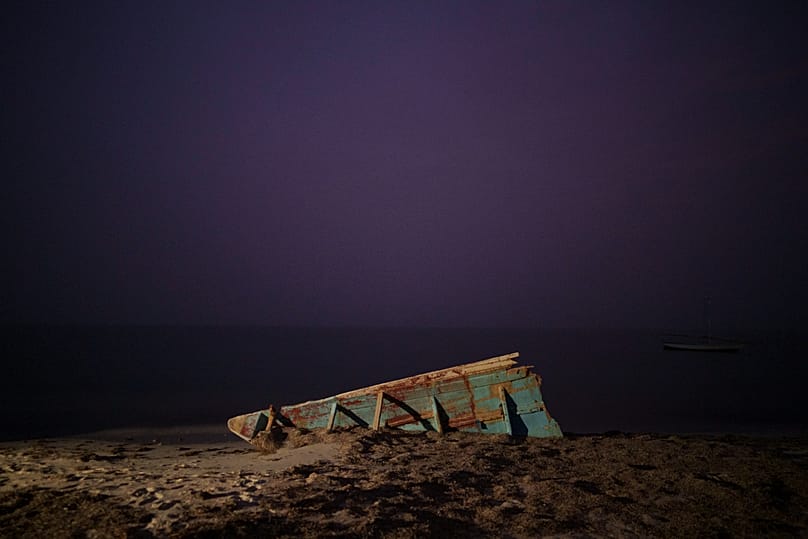 The wreck of a traditional Mauritanian fishing boat, known as a pirogue, on a beach near Nouadhibou, 2 December, 2021