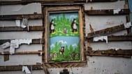 FILE: A banner depicting "Masha and Bear" is seen in a destroyed farm after a Russian attack near Brovary, Kyiv region, Ukraine, March 28, 2022.