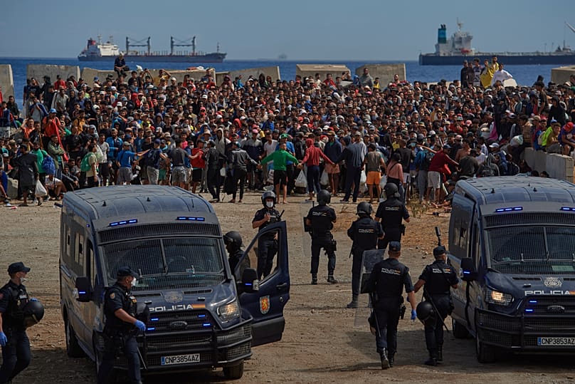 Migrants who crossed from Morocco into Spain return to a beach after being expelled from the area the previous day, 21 August, 2026
