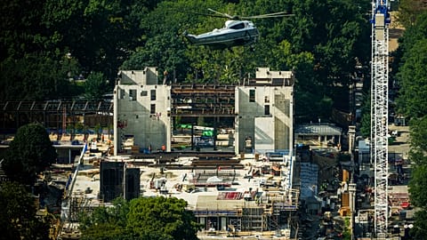 Marine One, with President Trump on board, flies over the construction site of the new White House ballroom (21 August 2026)