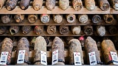 World War I shells, some marked in pink are suspect gas shells, are piled in a warehouse at the explosive disposal facility (DOVO) in Poelkapelle, Belgium, April 21, 2015.