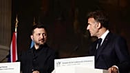Ukrainian President Volodymyr Zelensky, left, and French President Emmanuel Macron address a press conference after a Coalition of the Willing summit.