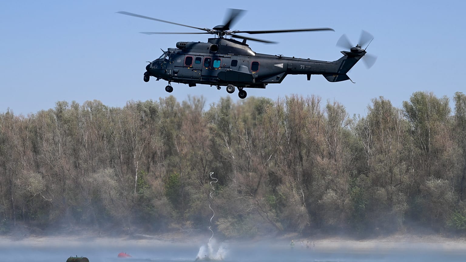 Betonkockát emel a Dunába a honvédség Airbus H225M típusú helikoptere a fenékküszöb építésének munkálatai során