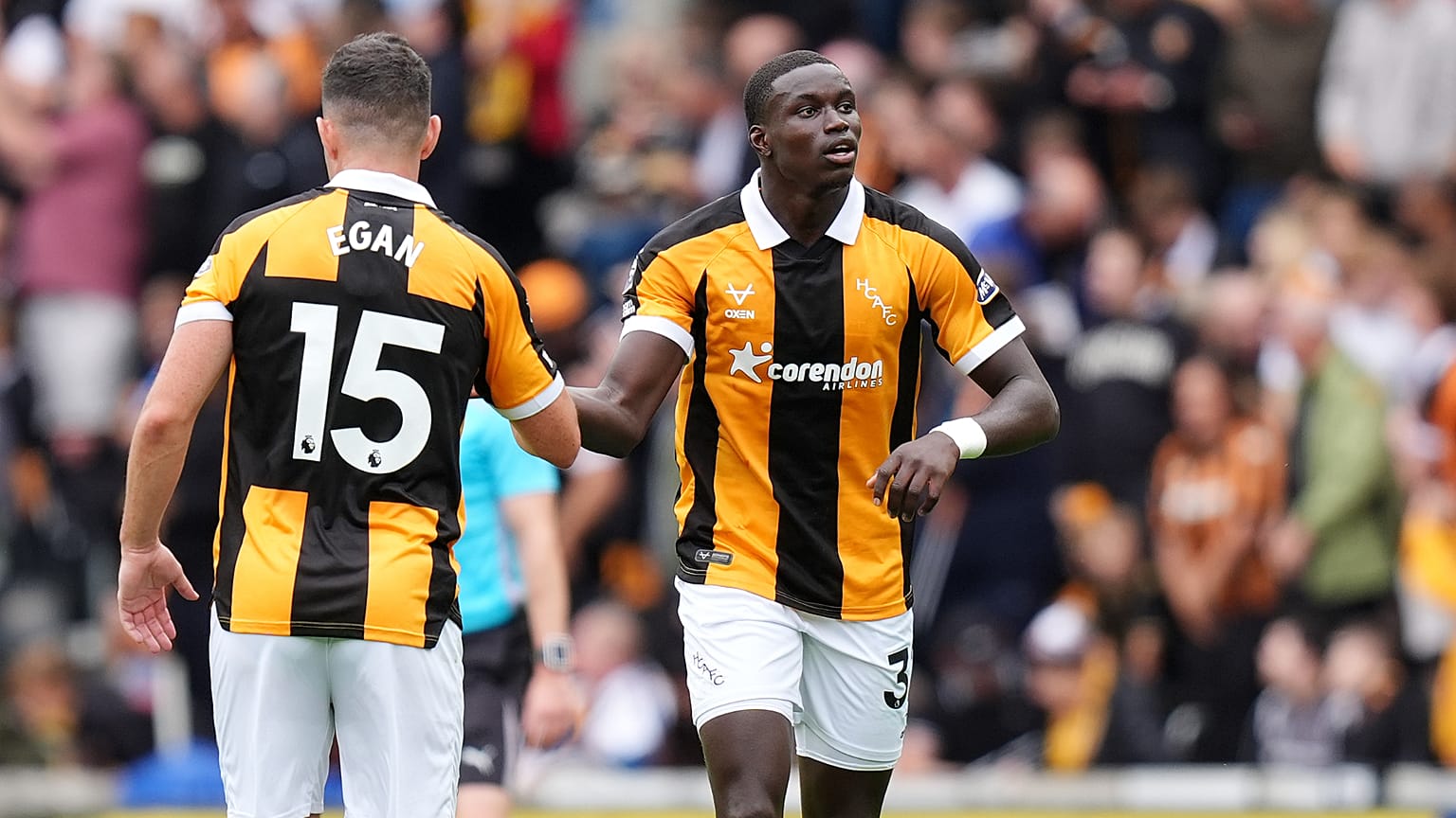 Hull City's Nobel Mendy, right, celebrates scoring during the English Premier League soccer match between Hull City and Manchester United i