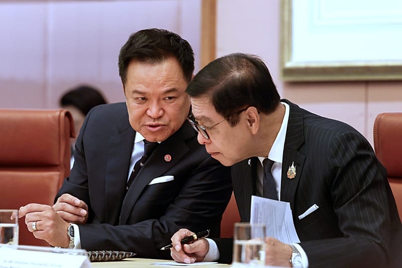 Thailand's Prime Minister Anutin Charnvirakul, left, speaks with a delegation member in Canberra, 19 August, 2026
