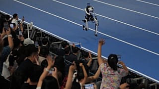 Spectators cheer a robot competing in the 1500m during the World Humanoid Robot Games in Beijing, Sunday, Aug. 23, 2026. 