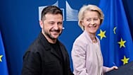 FILE - Ukraine's President Volodymyr Zelenskyy walks with European Commission President Ursula von der Leyen in Brussels, Belgium, 17 August, 2025.