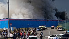 Smoke rises over a burning warehouse of the online retailer Ozon in Istra Municipal District
