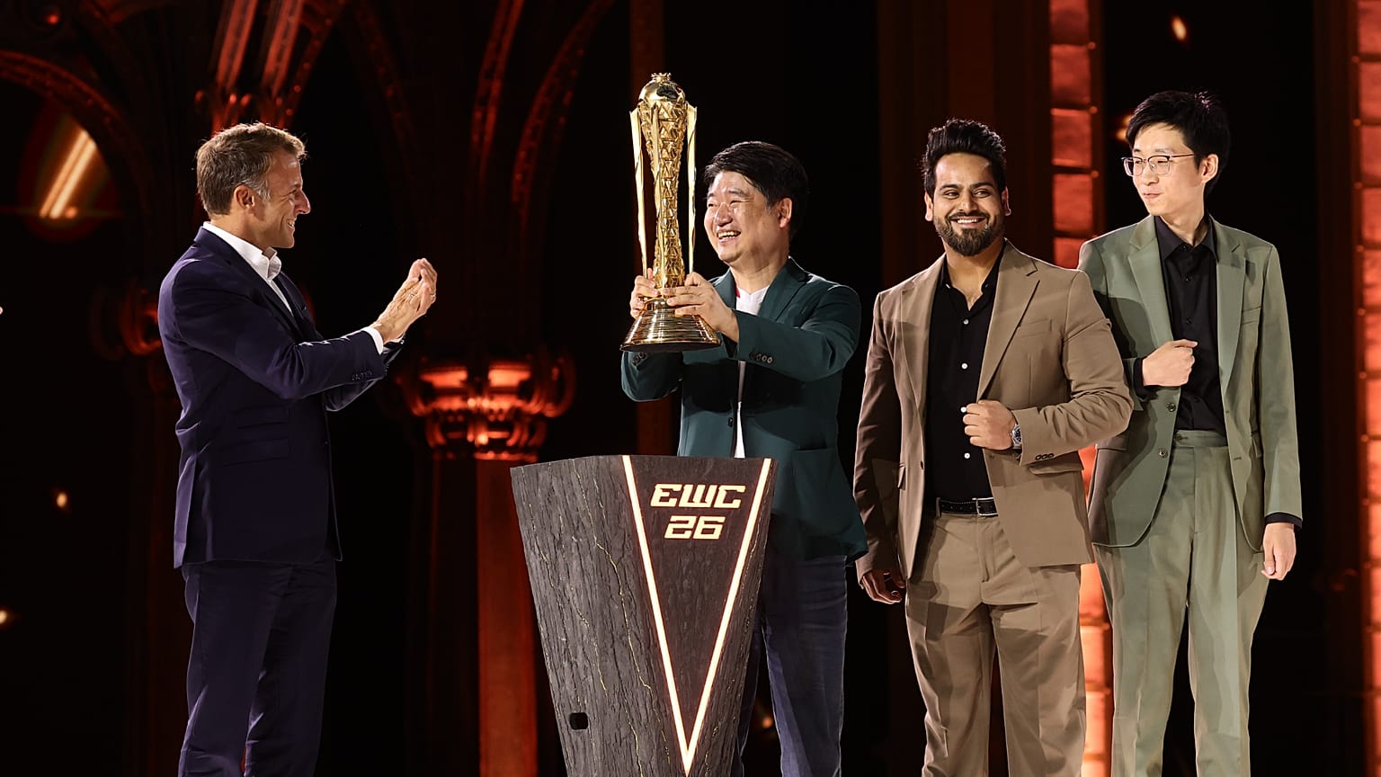 French President Emmanuel Macron presents the EWC 2026 Club champions award to AG.AL at the closing ceremony of the Esports World Cup in Paris, France, on Aug. 23, 2026.