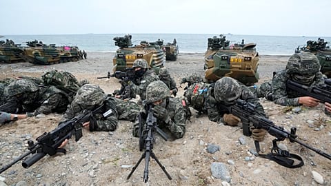 South Korean Marines take positions after landing on the beach during joint military amphibious drills with the US in Pohang, 2 September, 2024