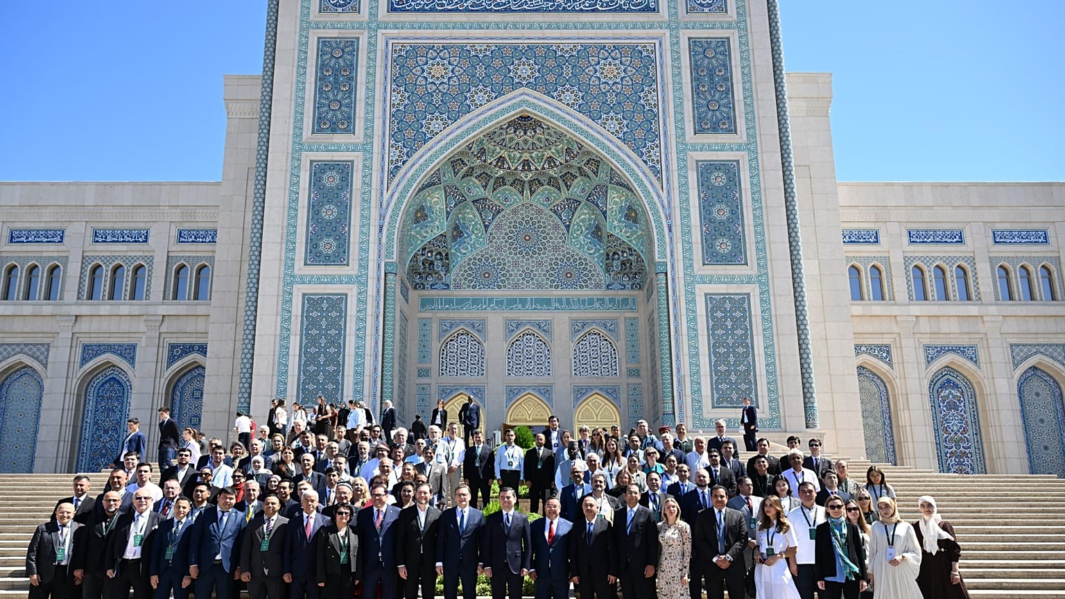 Participants in the International Media Forum pose for a group photo outside the Centre of Islamic Civilisation in Tashkent, Uzbekistan