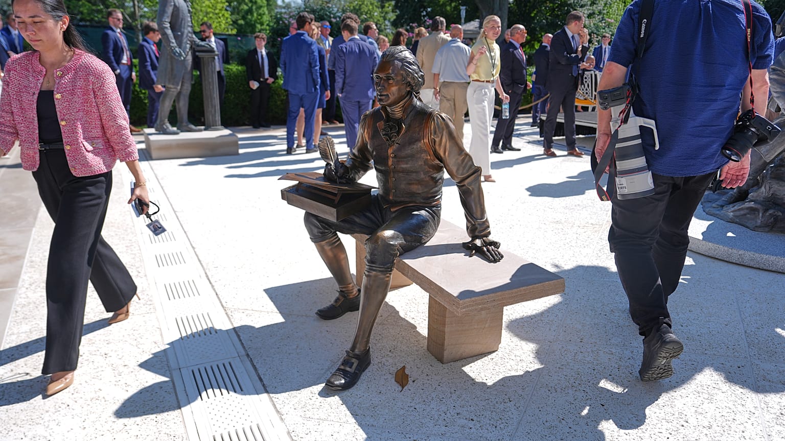 A bronze depiction of Thomas Jefferson seated and signing the Declaration of Independence in the Rose Garden of the White House
