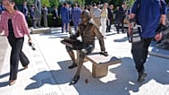 A bronze depiction of Thomas Jefferson seated and signing the Declaration of Independence in the Rose Garden of the White House