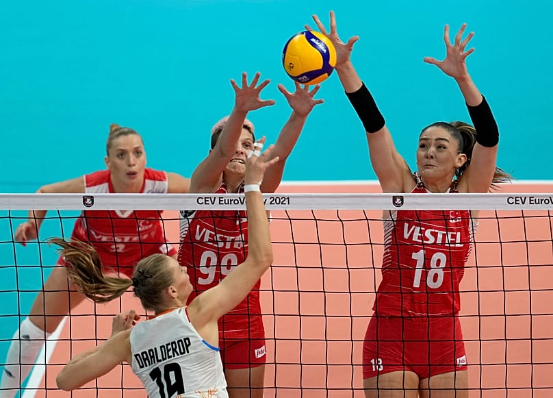 Netherlands' Nika Daalderop, front, spikes the ball against Turkey's Zehra Gunes, right, and Ebrar Arakurt during the 2021 Women's European Volleyball Championship