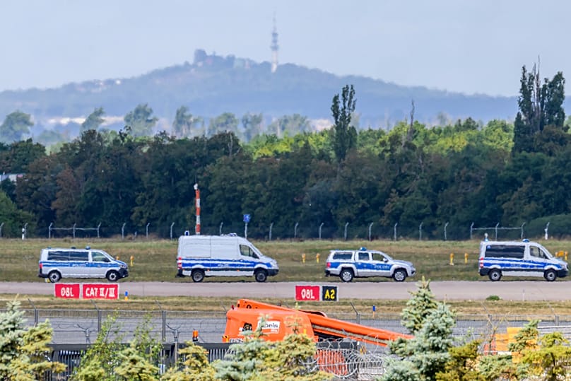 Police vehicles parked along the north runway at Leipzig/Halle Airport, 6 August, 2026