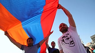FILE: Supporters of Nikol Pashinian wave an Armenian flag during a demonstration in Republic Square in Yerevan on Wednesday, 2 May 2018