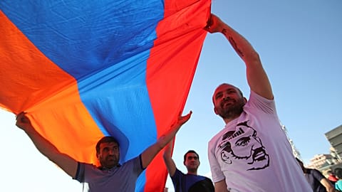 FILE: Supporters of Nikol Pashinian wave an Armenian flag during a demonstration in Republic Square in Yerevan on Wednesday, 2 May 2018