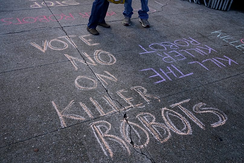 Messages written on the sidewalk are shown during a demonstration about the use of robots by the San Francisco Police Department, 5 December, 2022
