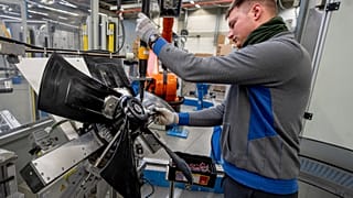 File - A man works on fans at an EBM-Papst plant in Hollenbach, Germany, Tuesday, 4. February 2025. 