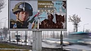 FILE: Cars drive past an advertising billboard which promotes contract military service in the Russian army in St Petersburg, 24 February 2024