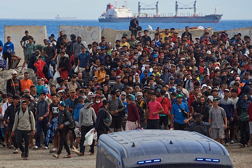 Migrantes que cruzaron de Marruecos a España regresan a una playa tras haber sido expulsados ​​de la zona el día anterior, en Ceuta, el viernes 21 de agosto de 2026.